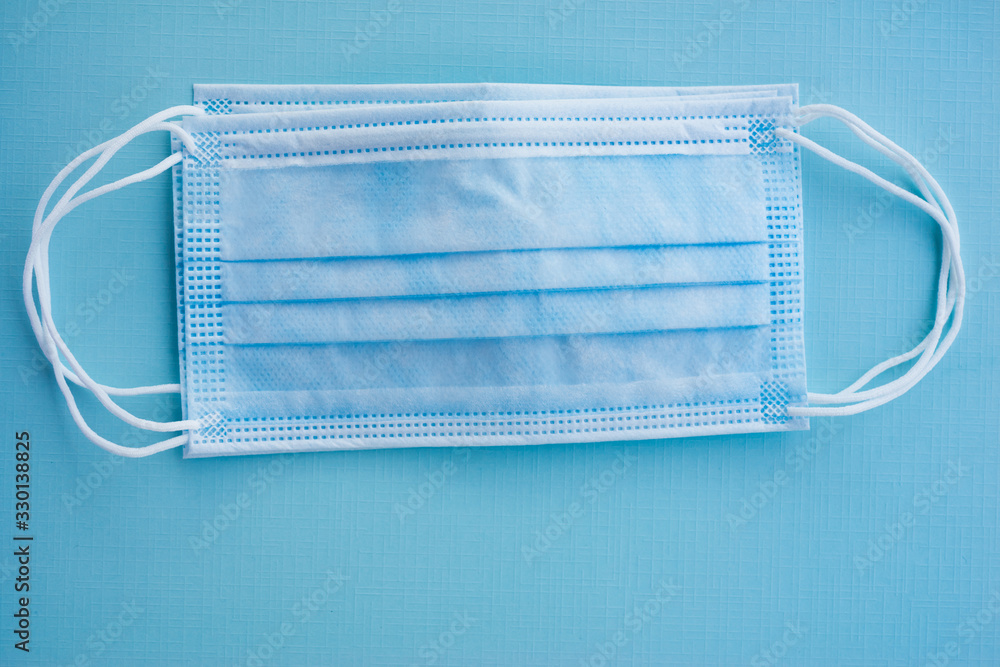 Blue Medical Disposable Face Mask on it. Covid-19 - Wuhan Novel Disposable breath filter face mask with earloop.concept of Corona virus quarantine,Covid-19 Blue Medical Disposable Face Mask on it. Covid-19 - Wuhan Novel Disposable breath filter face mask with earloop.concept of Corona virus quarantine,Covid-19