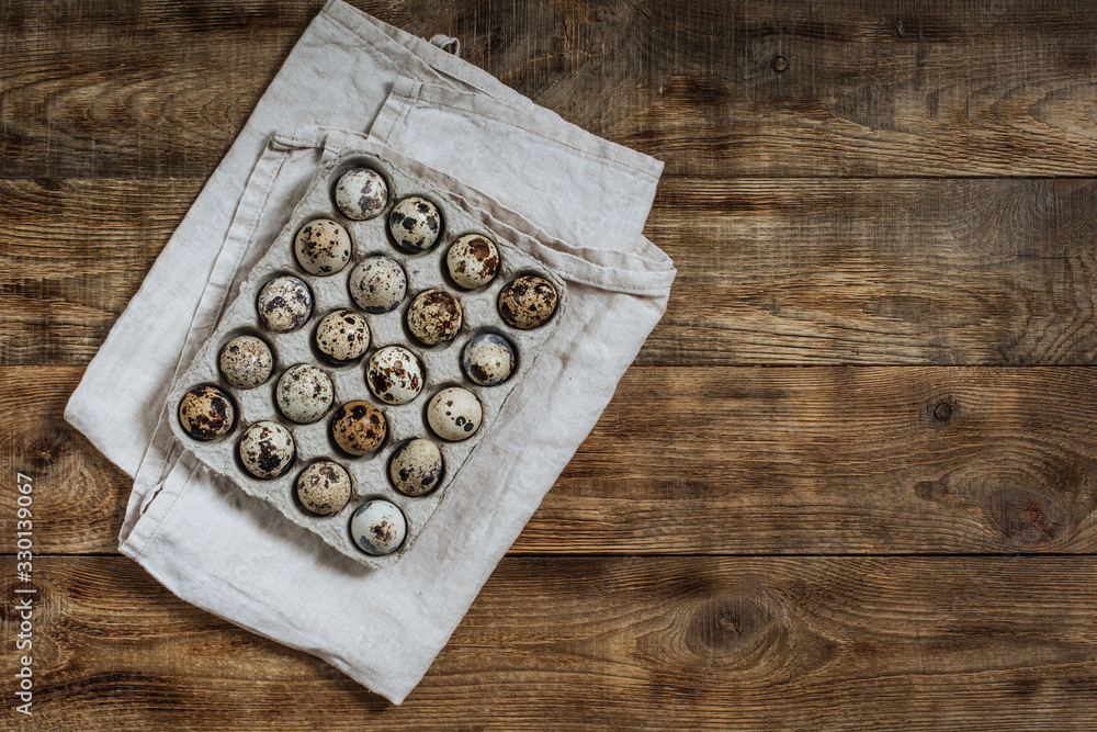 On a wooden table quail eggs in a box On a wooden table quail eggs in a box