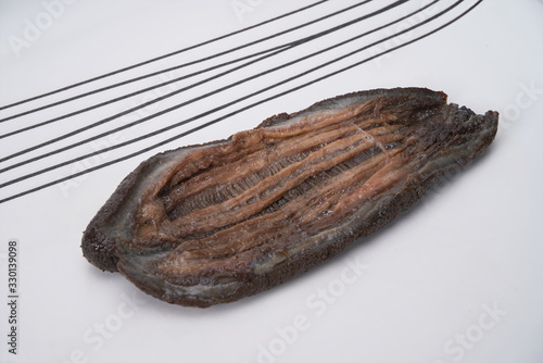 After the fresh sea cucumber is cut with a knife, it is under the white background photo