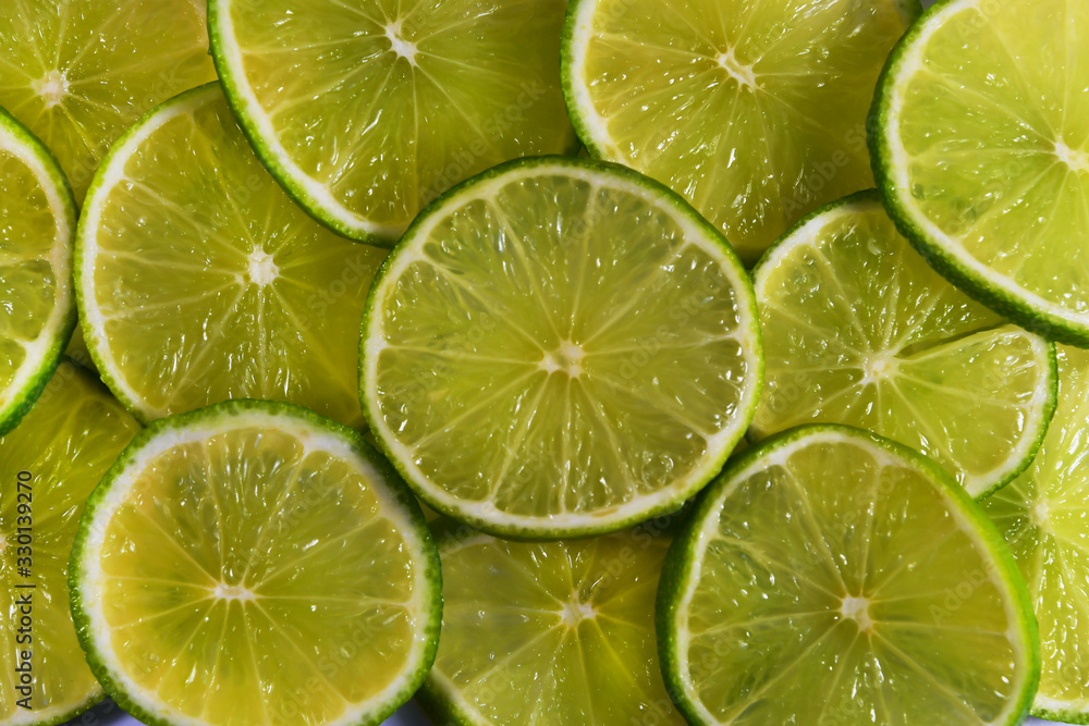 Background of slices of green and yellow lime Background of slices of green and yellow lime