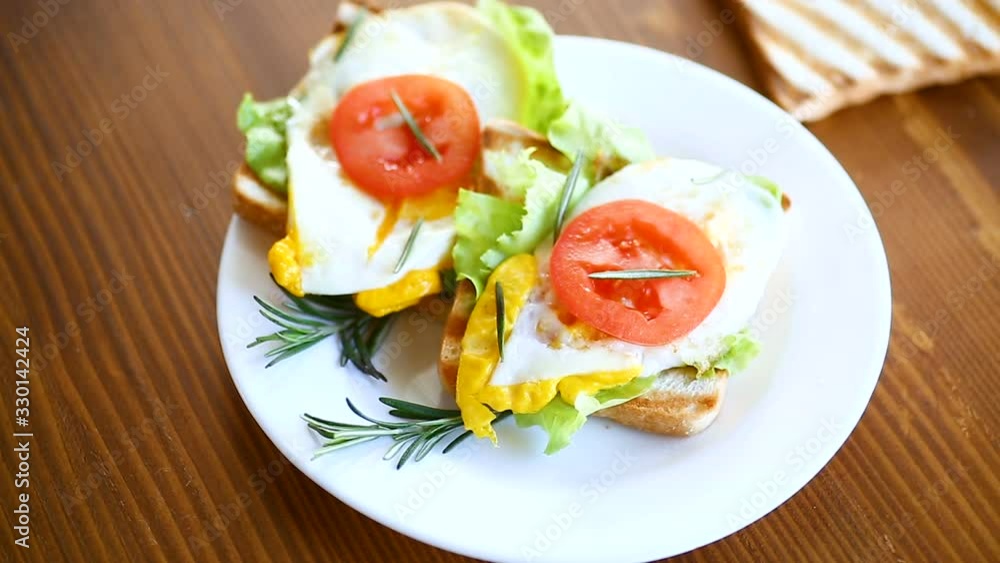 fried toasts with egg, salad, tomato in a plate fried toasts with egg, salad, tomato in a plate