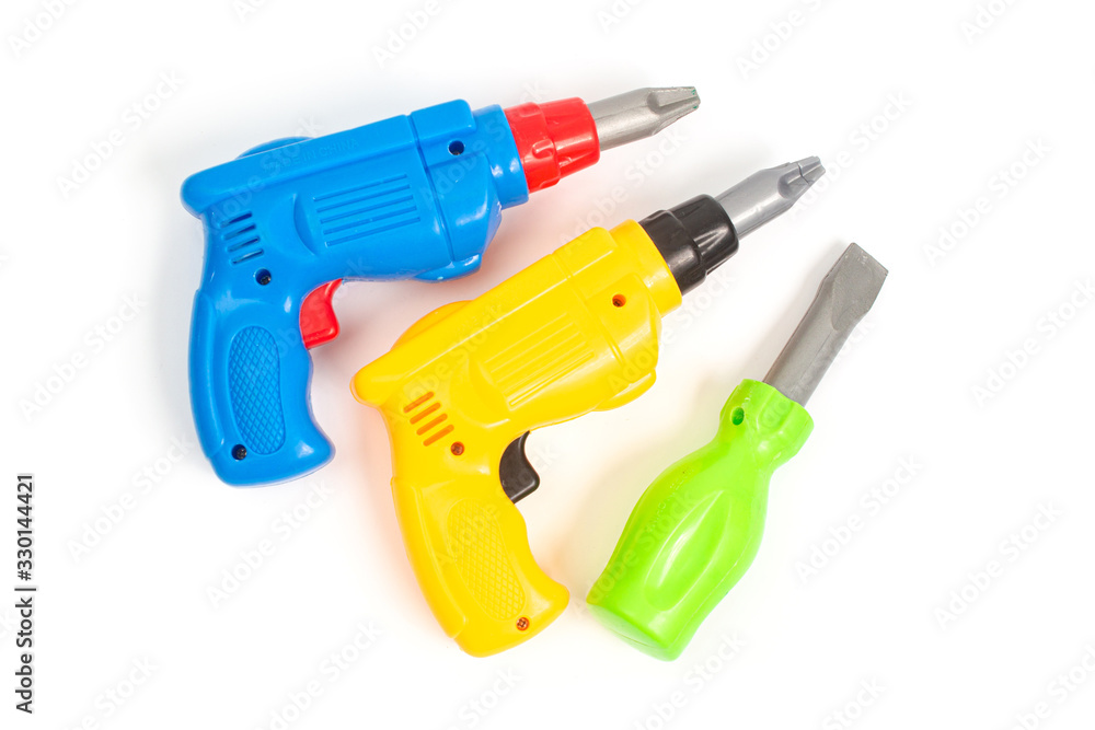 blue and yellow toy screwdriver and green screwdriver on a white background isolate, top view blue and yellow toy screwdriver and green screwdriver on a white background isolate, top view