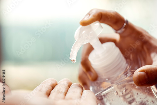 Принти на полотні Hand pumping alcohol gel or sanitizer gel to others hand for washing, cleaning hand for kill the virus or bateria