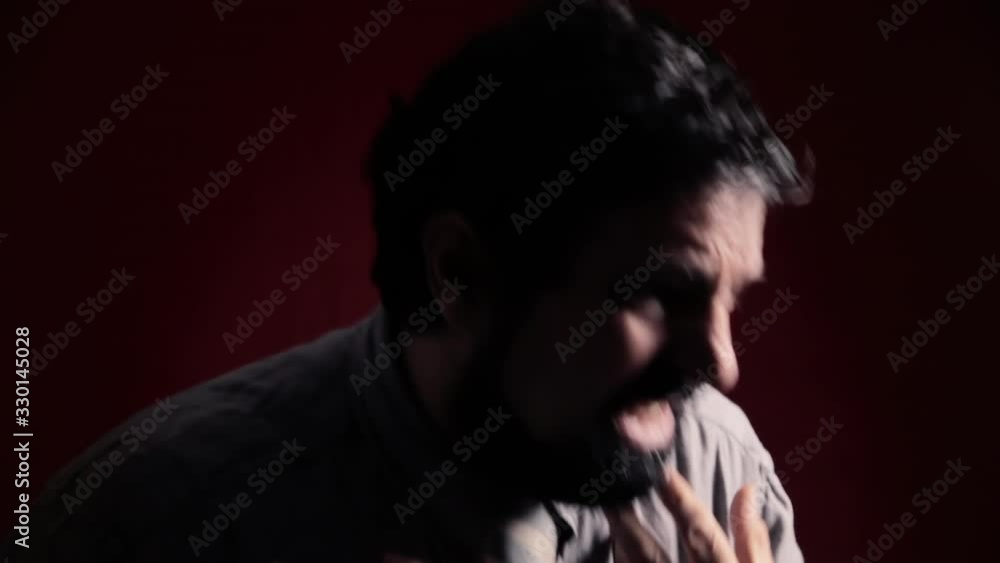 A depressed man, showing a self-critical expression. Shot with artistic intentional darkness and contrast. Part of a series of depictions of feelings and emotions with professional actors. A depressed man, showing a self-critical expression. Shot with artistic intentional darkness and contrast. Part of a series of depictions of feelings and emotions with professional actors.