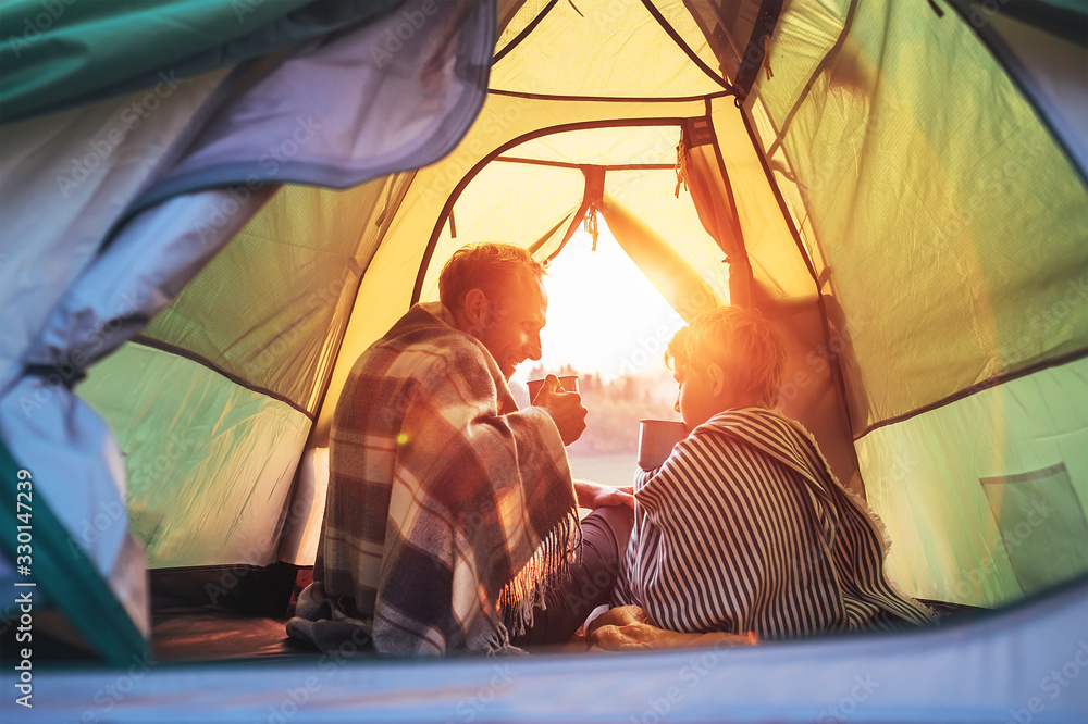 Father and son drink hot tea sitting together in camping tent. Traveling  with kids and active people concept image. Stock Photo | Adobe Stock