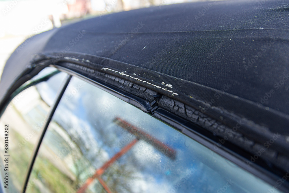 Obraz premium Convertible fabric roof repair, torn material, rubber seals.