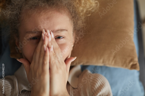Wallpaper Mural Portrait of young upset woman closing her face with hands and crying while lying on the sofa Torontodigital.ca