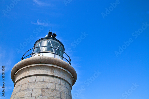 Looking up at the top of a lighthouse with blue skyies photo