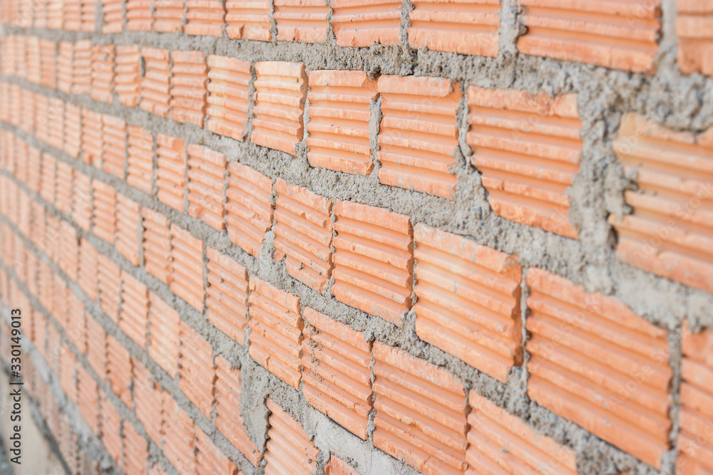 Fototapeta premium Close up view of a brick wall on a construction site, Construction concept.