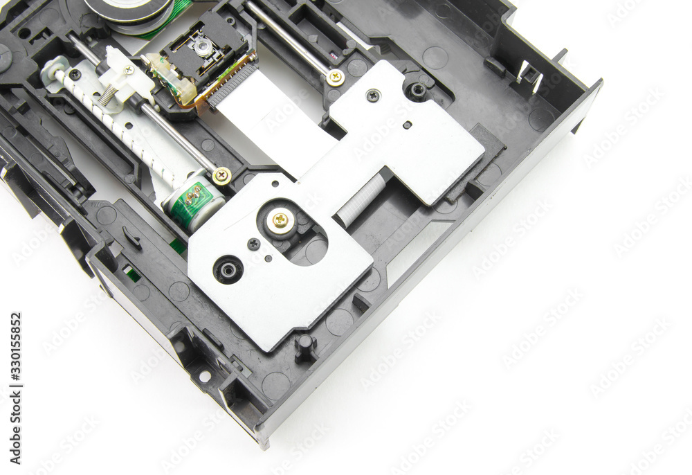 Disassembled optical CD-ROM drive in black. Opened CD reader. Drive, laser, motor, gears and other mechanisms. White isolated background. Disassembled optical CD-ROM drive in black. Opened CD reader. Drive, laser, motor, gears and other mechanisms. White isolated background.