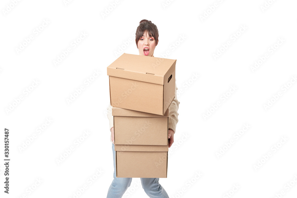 Clumsy woman carrying stack of falling cardboard boxes Clumsy woman carrying stack of falling cardboard boxes