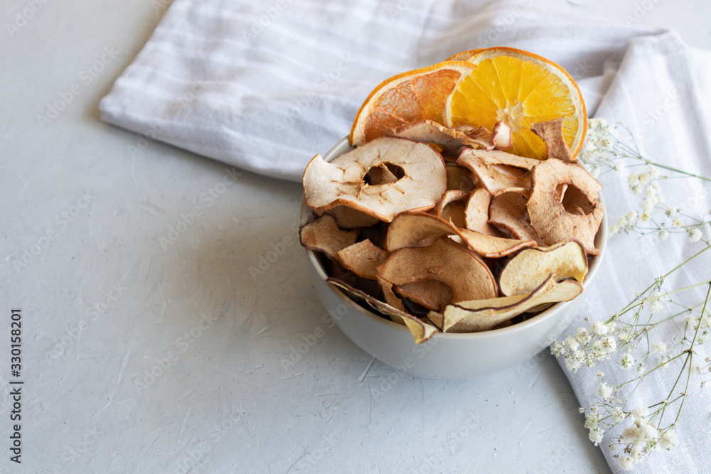 Close-up, top view, healthy chips for kids, orange and apple chips in a bowl, healthy snack
