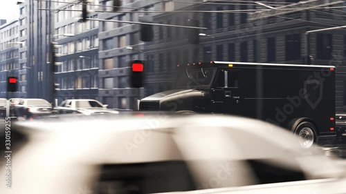 A heavy, black armoured truck going through the city during rainy weather. 4KHD