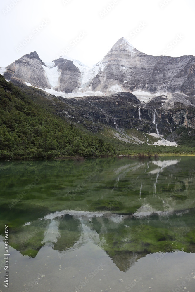 Cristal water Yading Nature Reserve, China Asia. Mountains and reflection in pure water. Cristal water Yading Nature Reserve, China Asia. Mountains and reflection in pure water.