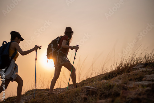 Two young Asian female  hiking on mountain holiday, wild adventure. Background for Travel concept