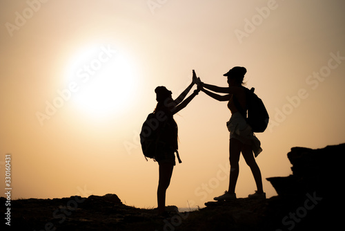Two young Asian female  hiking on mountain holiday, wild adventure. Background for Travel concept