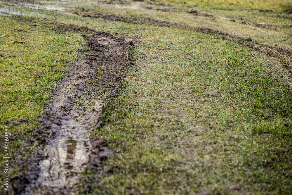 dirty mud road in winter with water on the road surface dirty mud road in winter with water on the road surface