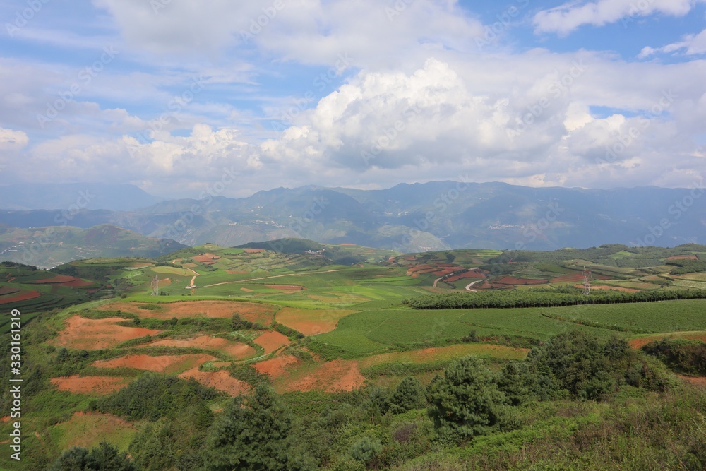 Red land Chinese village. Countryside landscape fields. Small town in China Yunnan Asia 
