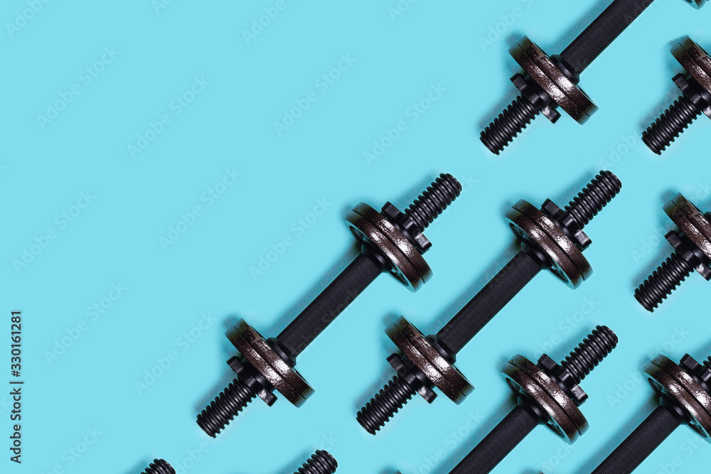 Sports picture. Dumbbells on blue background. Flat lay, top view, copy space. Sports picture. Dumbbells on blue background. Flat lay, top view, copy space.