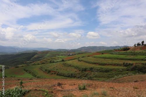 Red land Chinese village. Countryside landscape fields. Small town in China Yunnan Asia 