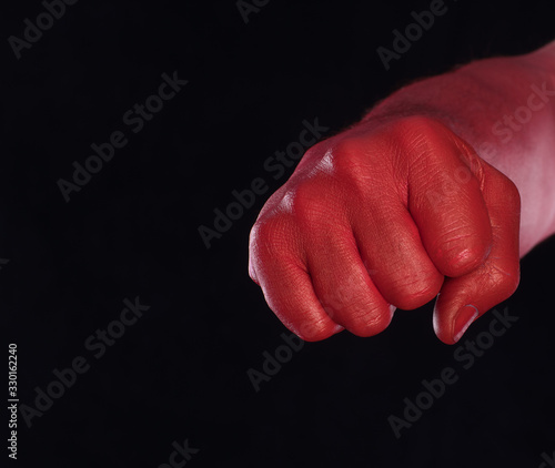 red bloody fist on a black background