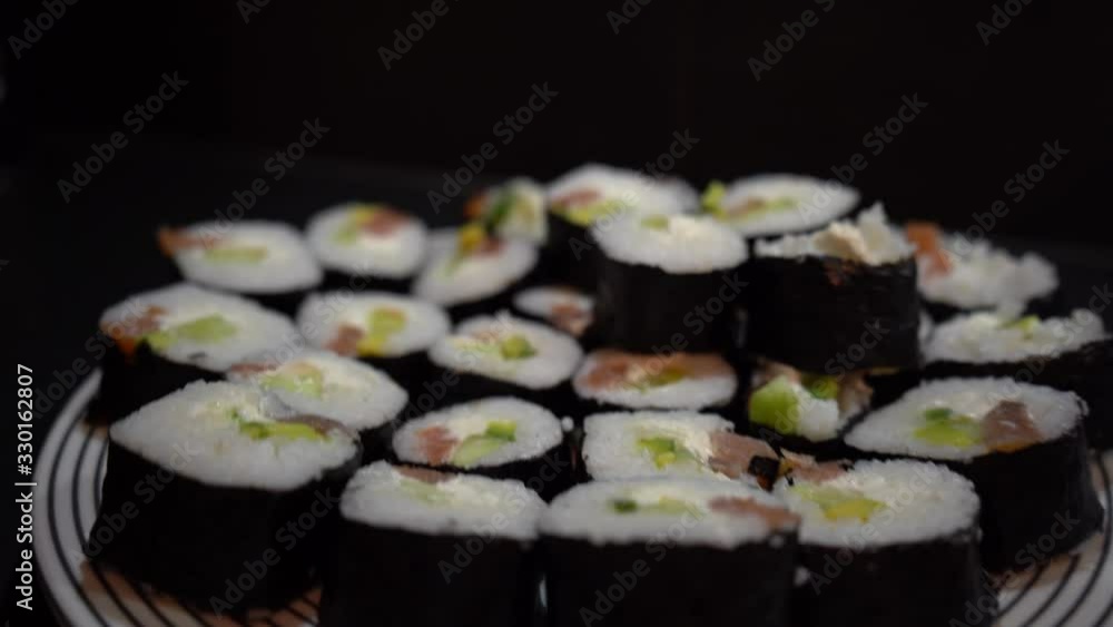 Girl takes nori leaves for sushi making. Cooking sushi at home Girl takes nori leaves for sushi making. Cooking sushi at home