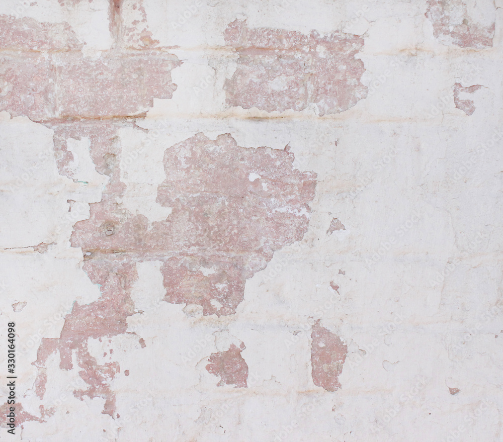 old plaster, light wall with white paint with beige and coral color.