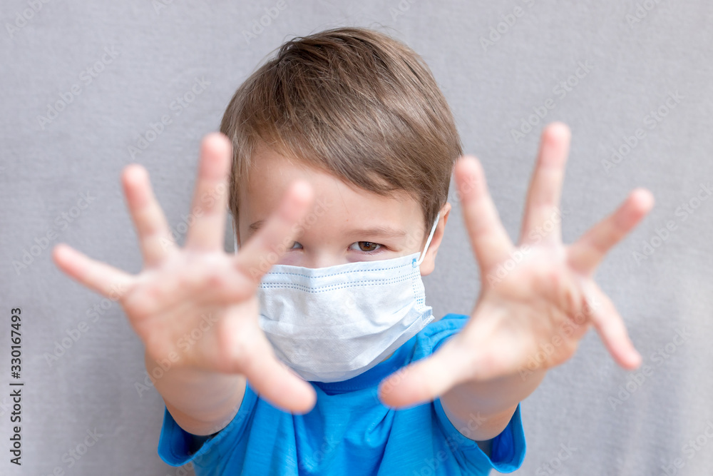 Portrait of Toddler kid wearing medical mask.A boy wearing mouth mask against air smog pollution. Concept of coronavirus quarantine or covid-19.Protection against virus and infection control concept. 