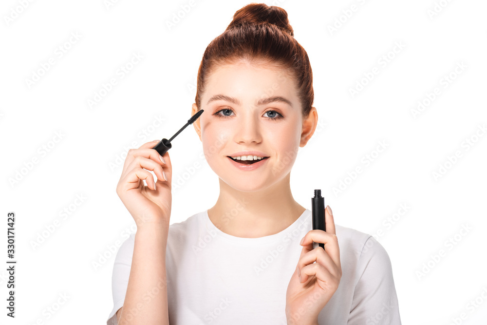 excited female teenager applying mascara, isolated on white excited female teenager applying mascara, isolated on white