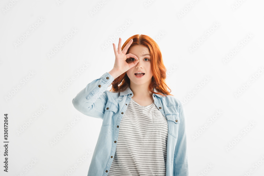 excited redhead female teenager showing ok sign, isolated on white excited redhead female teenager showing ok sign, isolated on white