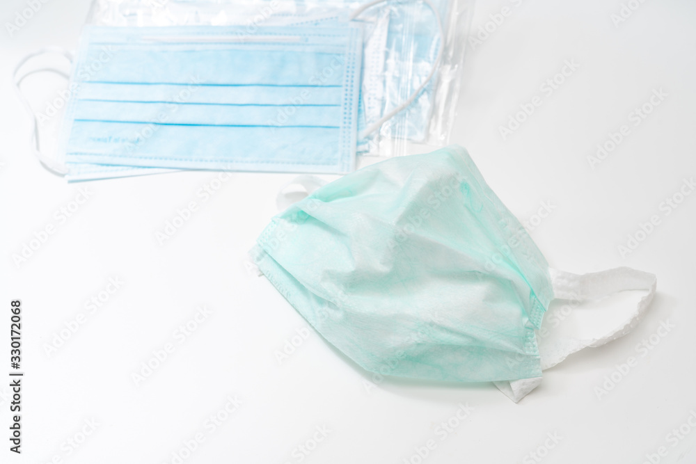 Fototapeta premium Surgical mask with rubber ear straps. Typical 3-ply surgical mask to cover the mouth and nose. Procedure mask from bacteria. Protection concept.