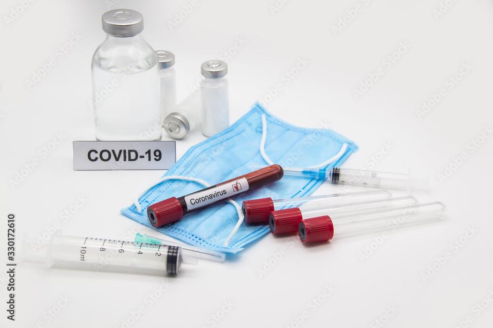 Coronavirus blood test concept. A test tubes with Coronavirus positive blood over laboratory desk. Covid-19 concept can be used in design Coronavirus blood test concept. A test tubes with Coronavirus positive blood over laboratory desk. Covid-19 concept can be used in design