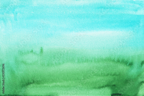 Watercolor light blue and green gradient background texture. Multicolored soft ombre backdrop, hand painted. Stains on paper.