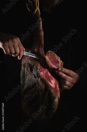 Dry Spanish ham, Jamon Serrano, Bellota, Italian Prosciutto Crudo or Parma ham, whole leg isolated on black background