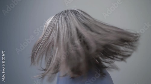 Pretty Middle Aged Mongolian Woman With Amazing Grey Hair Is Shaking Her Had And Smiling Broadly.She is Very Happy. Her face Is Covered With Wrinkles. Close-up Shot. Slow Motion