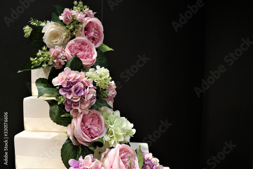 White wedding cake with flowers, roses