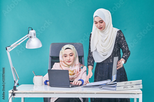 Office Lady with bundle of file on the table and laptop