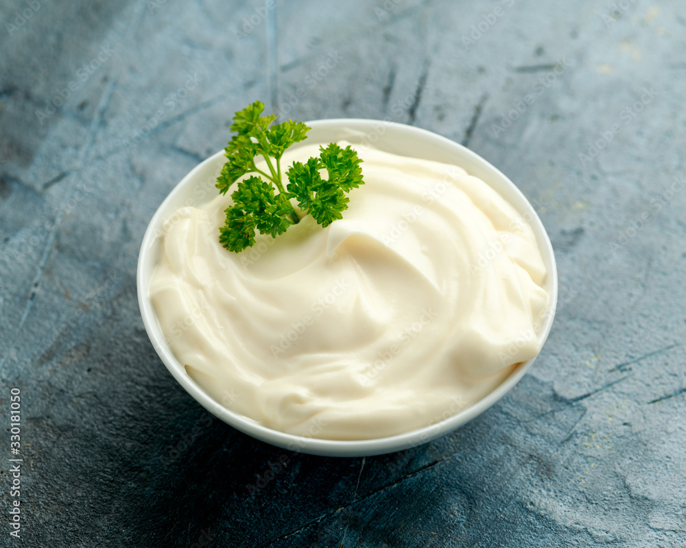 Mayonnaise sauce in a white bowl on old rustic table Mayonnaise sauce in a white bowl on old rustic table