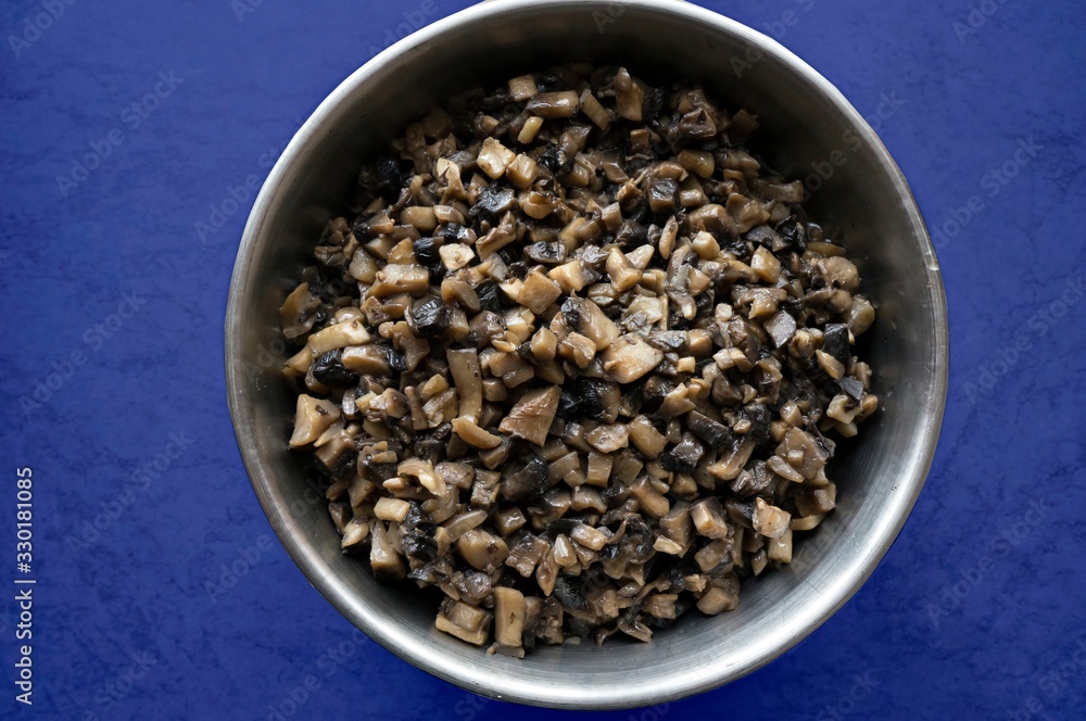fried mushrooms in a metal dish on a dark blue background fried mushrooms in a metal dish on a dark blue background