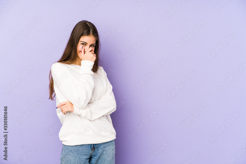 Young caucasian woman isolated on purple background laughing happy, carefree, natural emotion. Young caucasian woman isolated on purple background laughing happy, carefree, natural emotion.