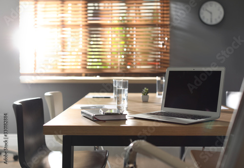 Wallpaper Mural Laptop on wooden table in modern office Torontodigital.ca