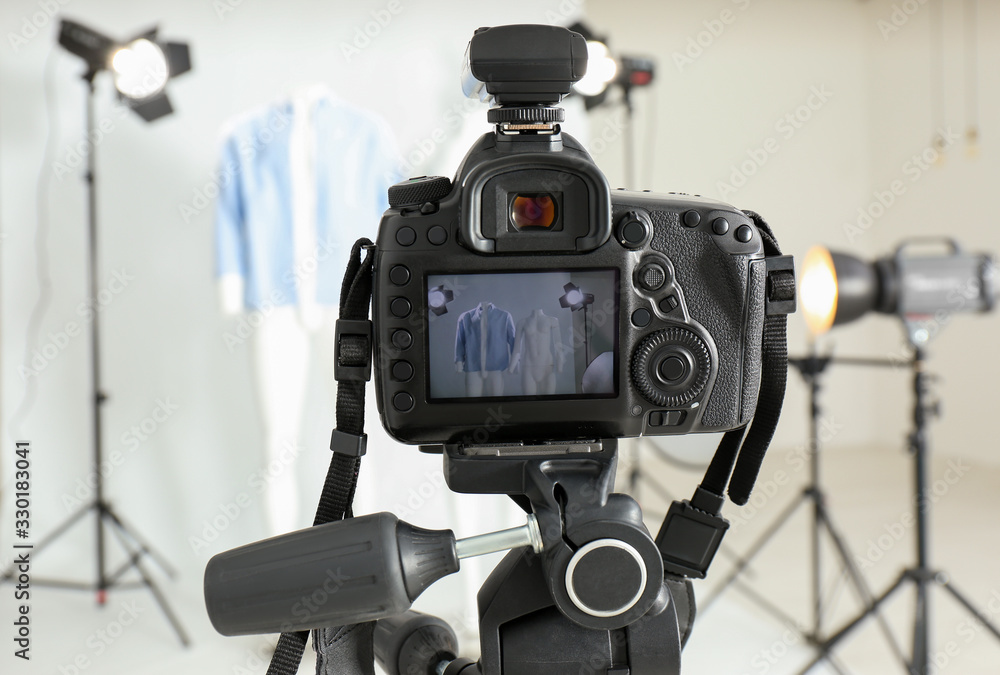 Taking pictures of ghost mannequin with modern clothes in professional photo studio, focus on camera Taking pictures of ghost mannequin with modern clothes in professional photo studio, focus on camera