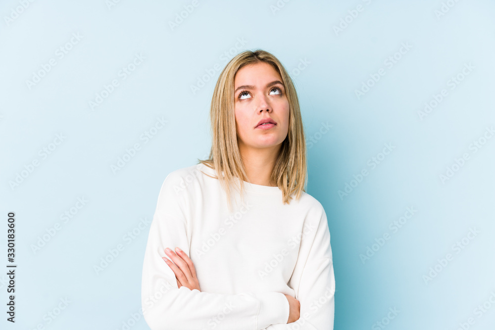 Young blonde caucasian woman isolated tired of a repetitive task. Young blonde caucasian woman isolated tired of a repetitive task.