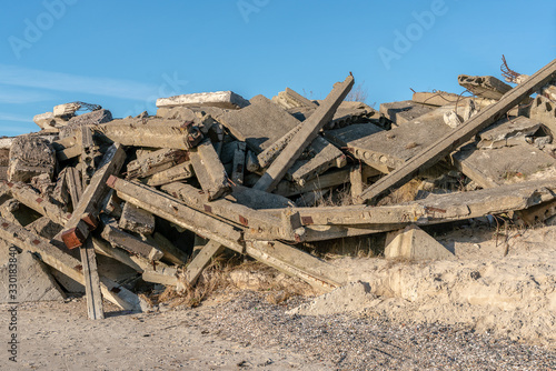 Construction debris - concrete blocks and stones dumped on seashore. Shore strengthening