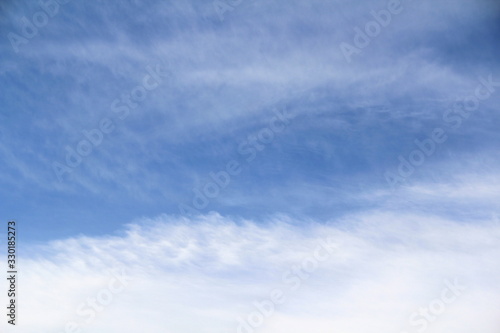 Cloudy blue sky with white and gray clouds. Background for text and design