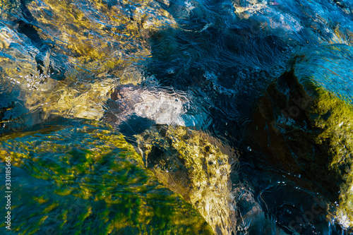 Some rocks submerged in the crystal clear water.