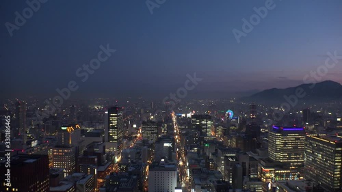 Wallpaper Mural SAPPORO, HOKKAIDO, JAPAN - FEB 2020 : Aerial high angle sunrise view of cityscape of Sapporo city. View of buildings and street traffic around Susukino downtown area. Time lapse shot night to morning. Torontodigital.ca