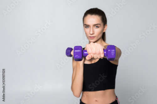 Fitness woman with dumbbell isolated on white background.