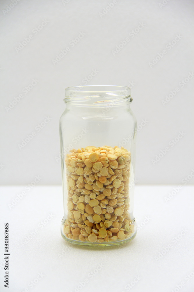 Glass jar with peas on a white background, side view. Glass jar with peas on a white background, side view.