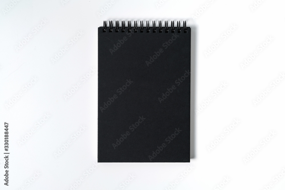 Notebook mock up with clean black blank for design and advertising. Notepad with chromed spring and free copy space template. On the gray background. Notebook mock up with clean black blank for design and advertising. Notepad with chromed spring and free copy space template. On the gray background.